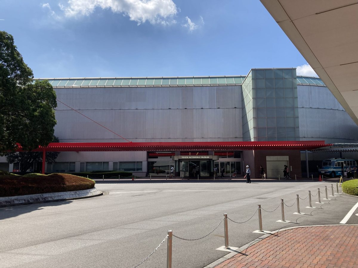 The museum's long silver hall, with the Toyota Automobile Museum entrance under its red canopy.